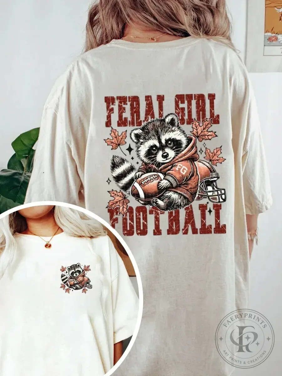 Graphic T-Shirt Featuring Raccoon Football Design for Feral Girls